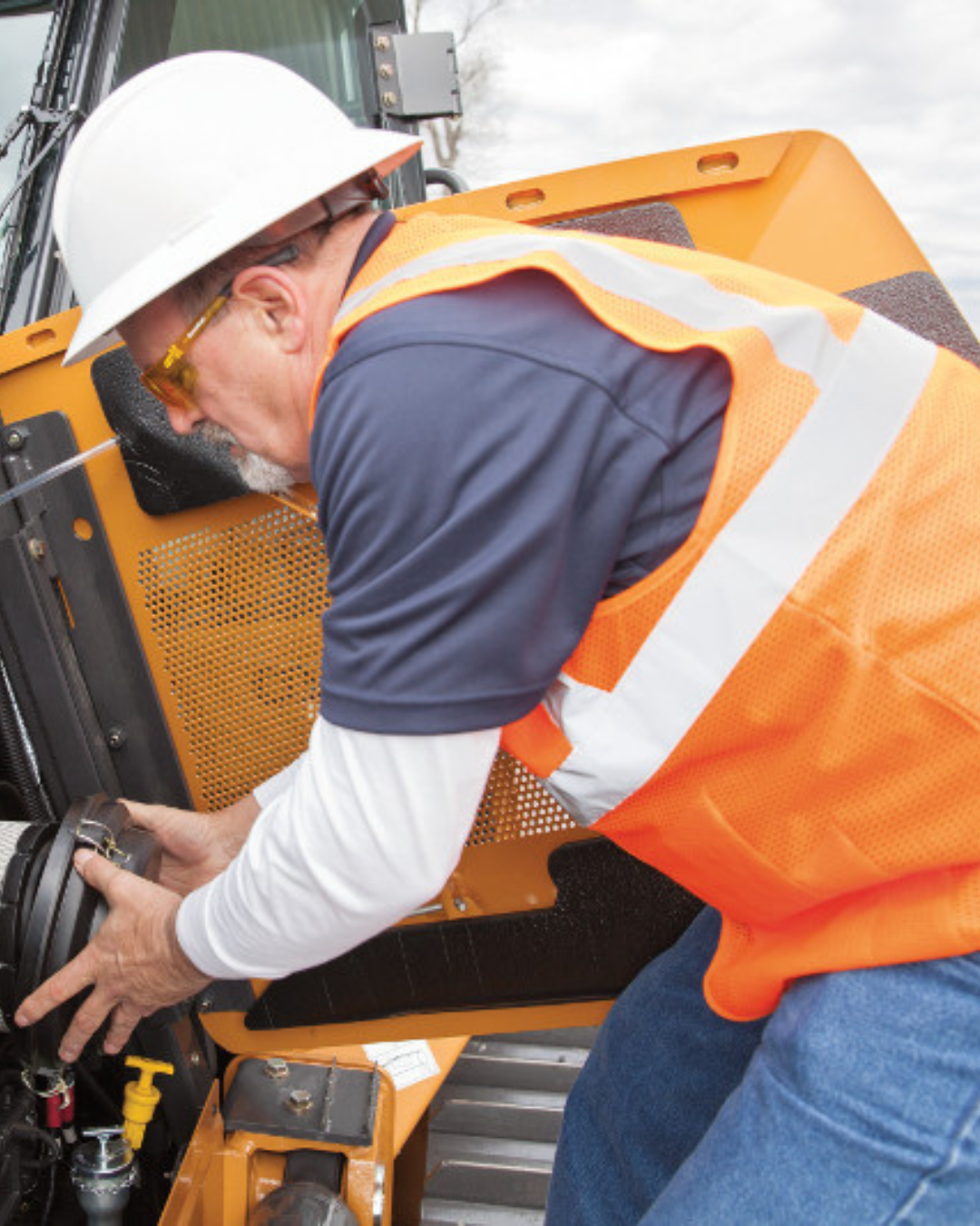 field tech servicing a backhoe